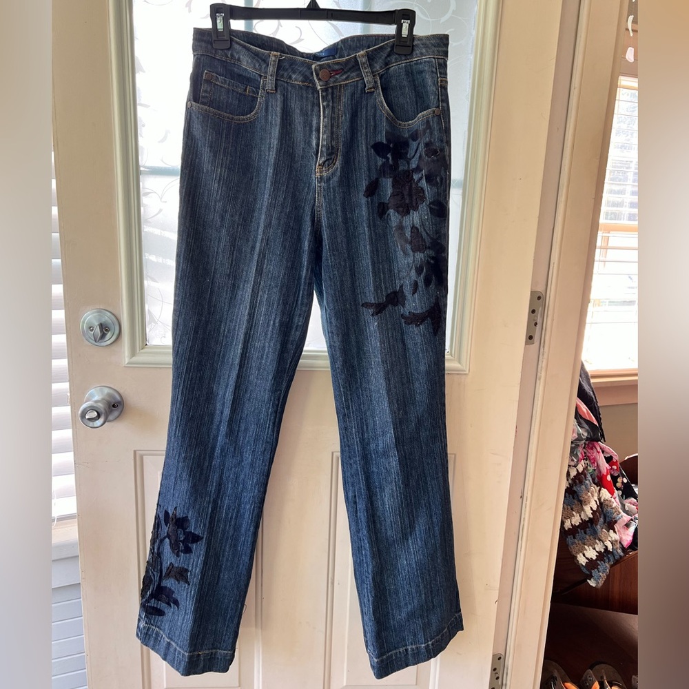 Bill Blass size 8 Y2K blue jeans with black floral embroidery to hip and shin.